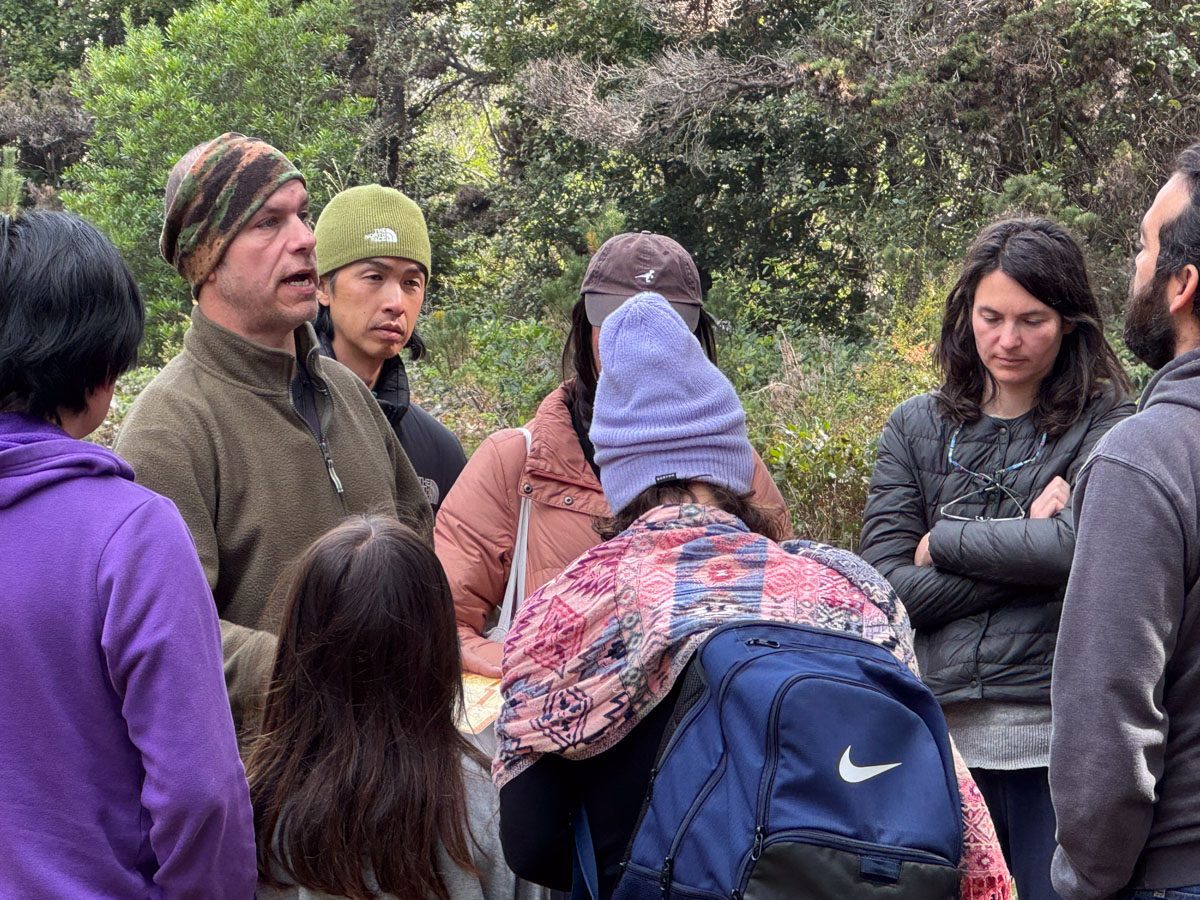 An instructor talking with a small group during a mushroom identification class